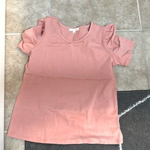 Pink shirt with ruffles on the sleeves